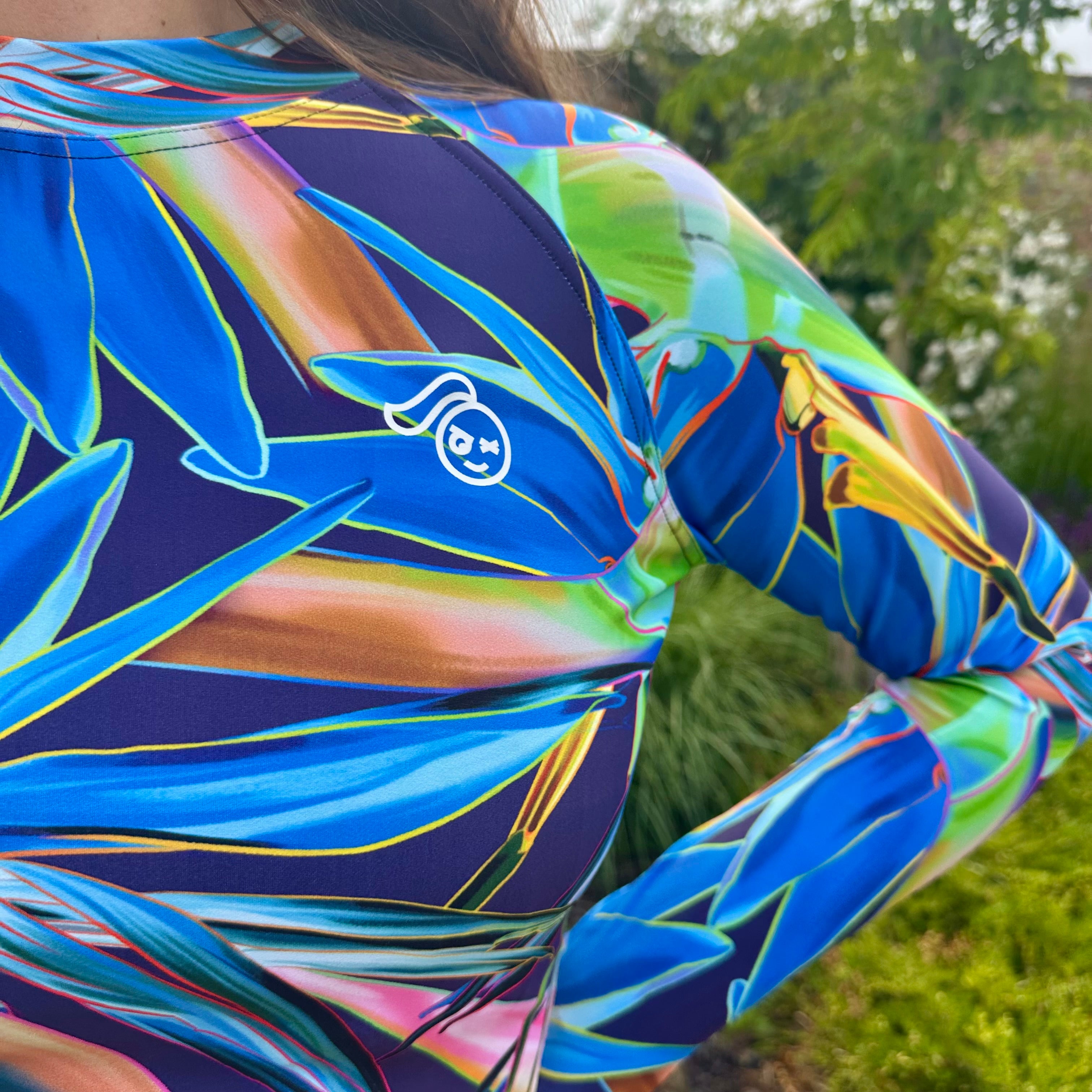 Tough Cherry Tropical Flora Midnight design Rash Guard close up Tough Cherry Logo