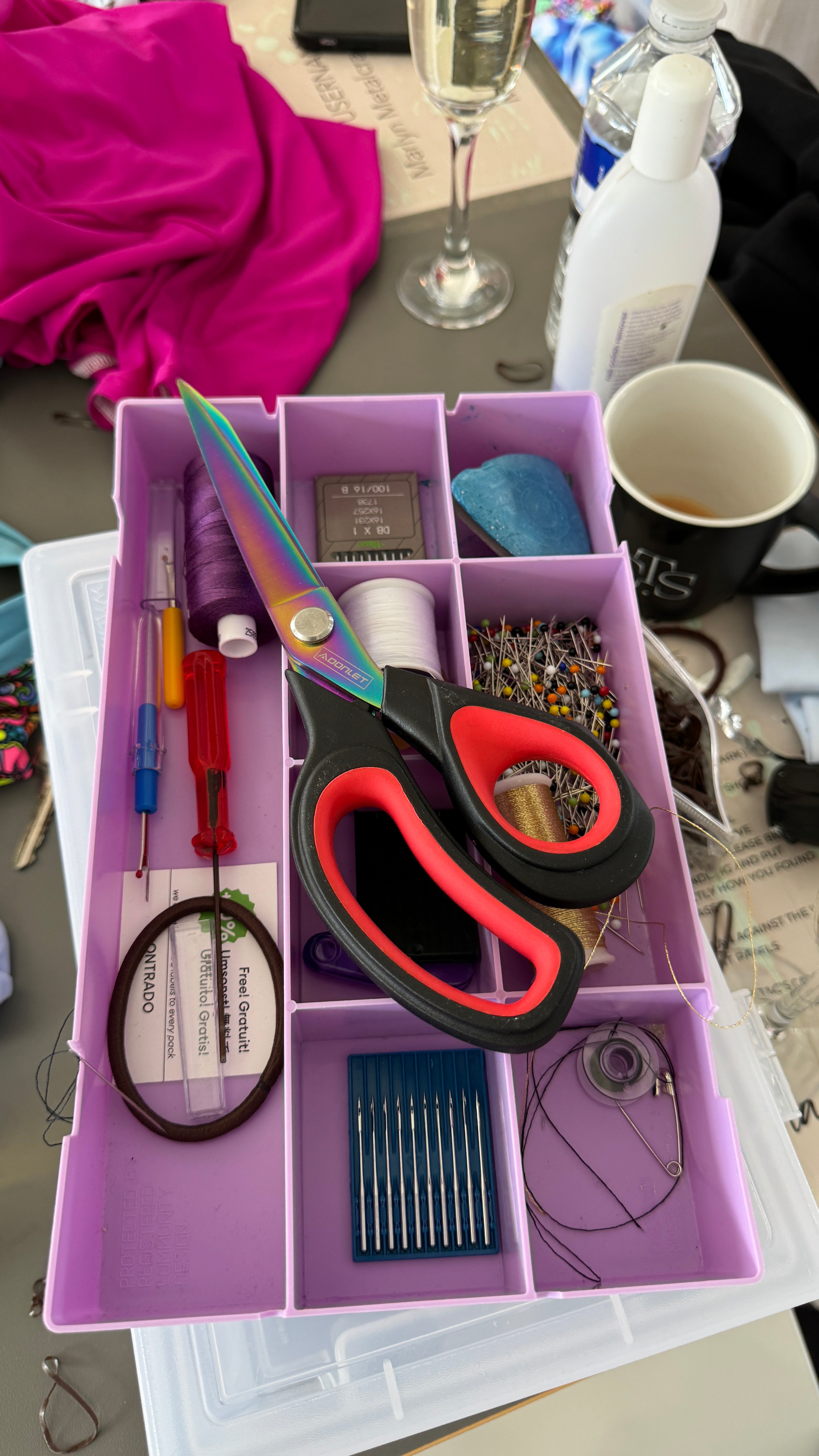 sewing box with needles and thread and fabric scissors on top