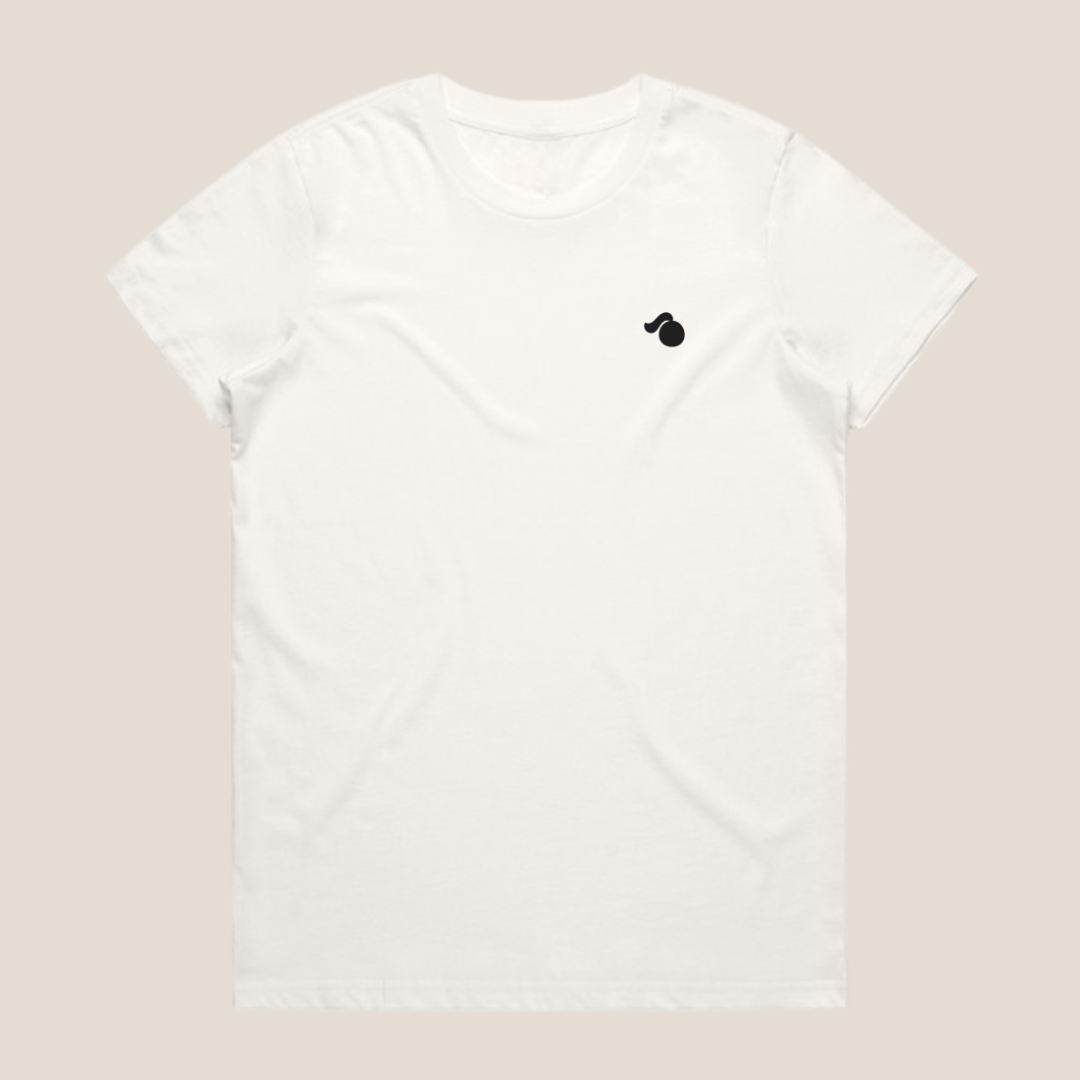 White oversized cotton t-shirt with a small black tough cherry logo on a beige background