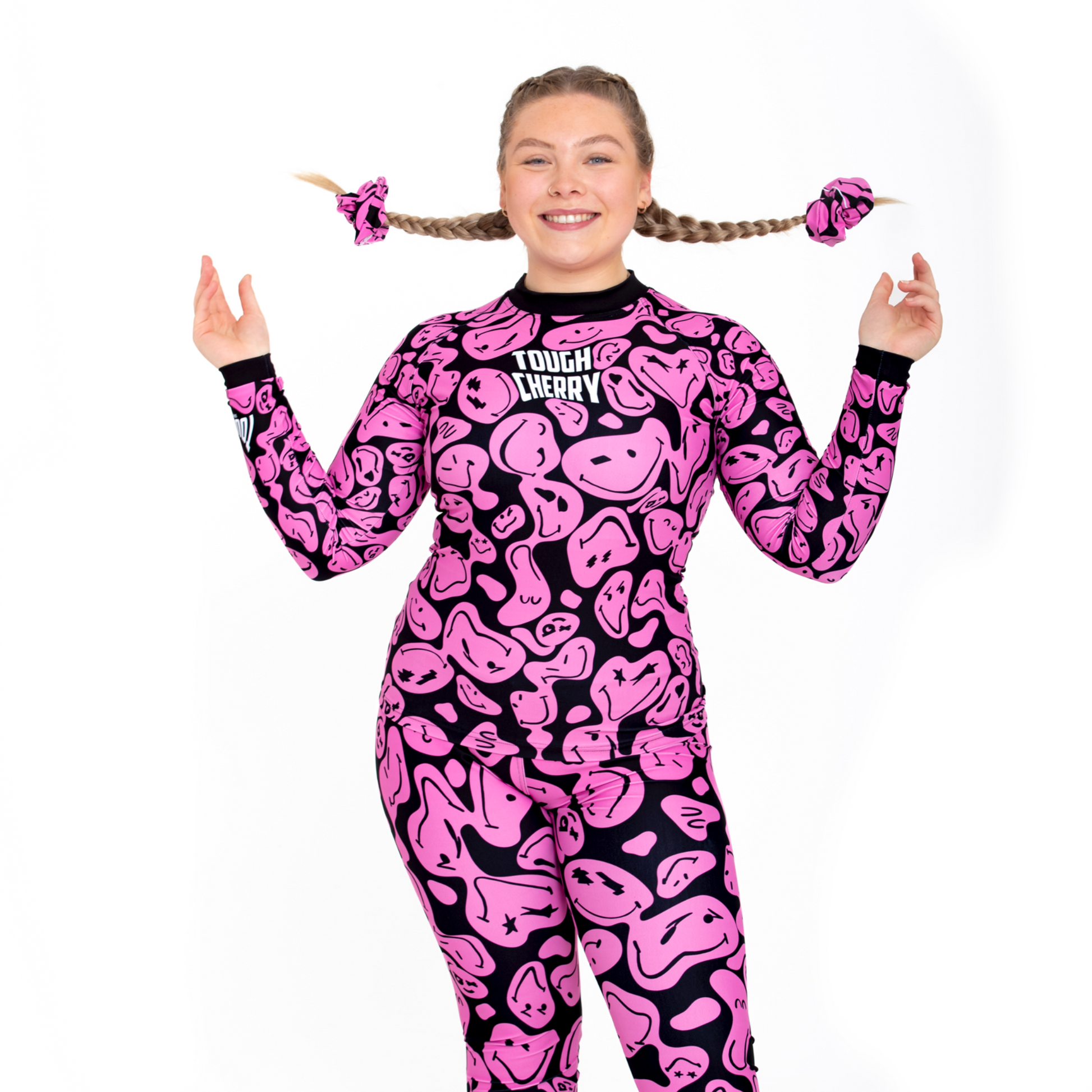 Women's and kids long sleeved pink and black smiley face rash guard, front view