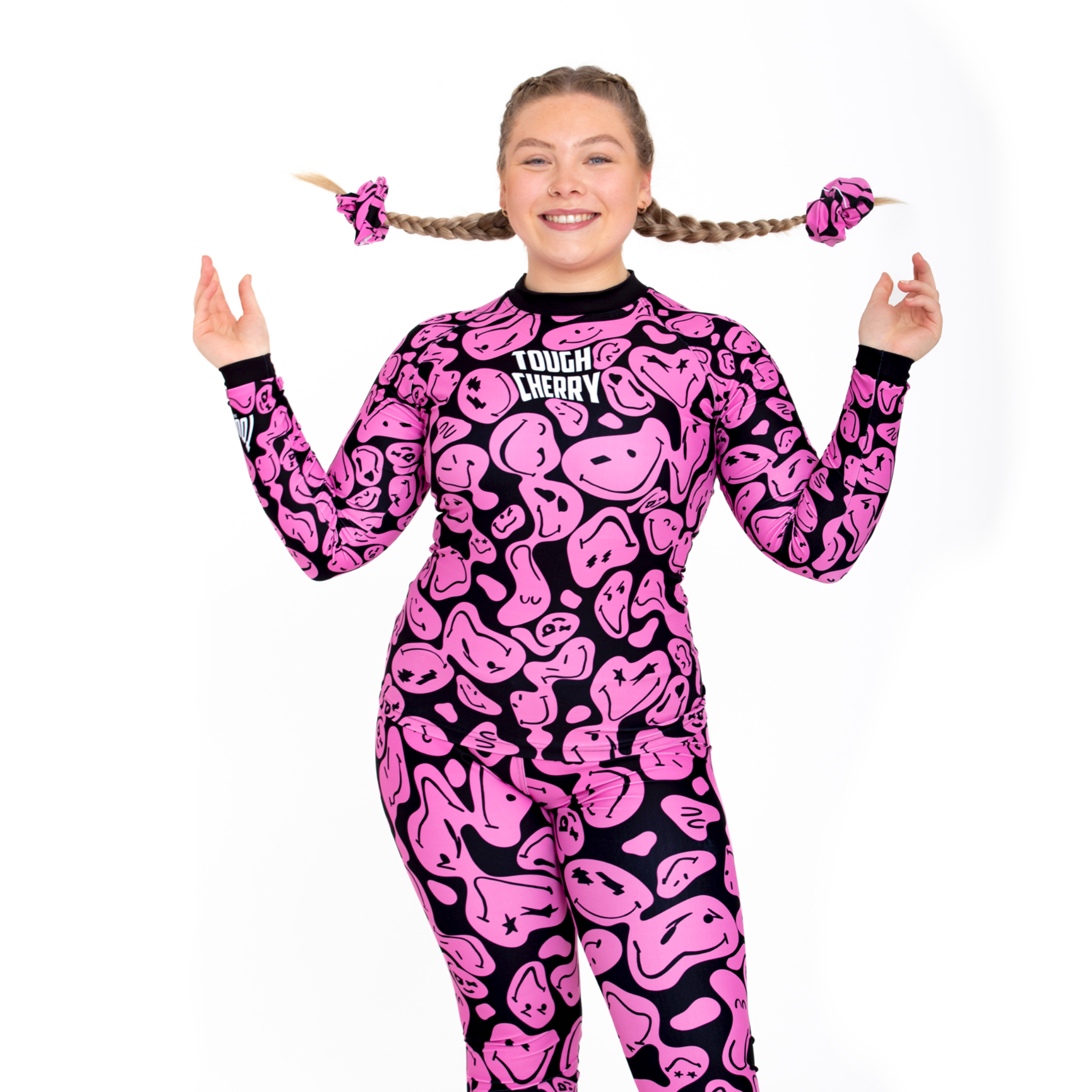 Women's and kids long sleeved pink and black smiley face rash guard, front view