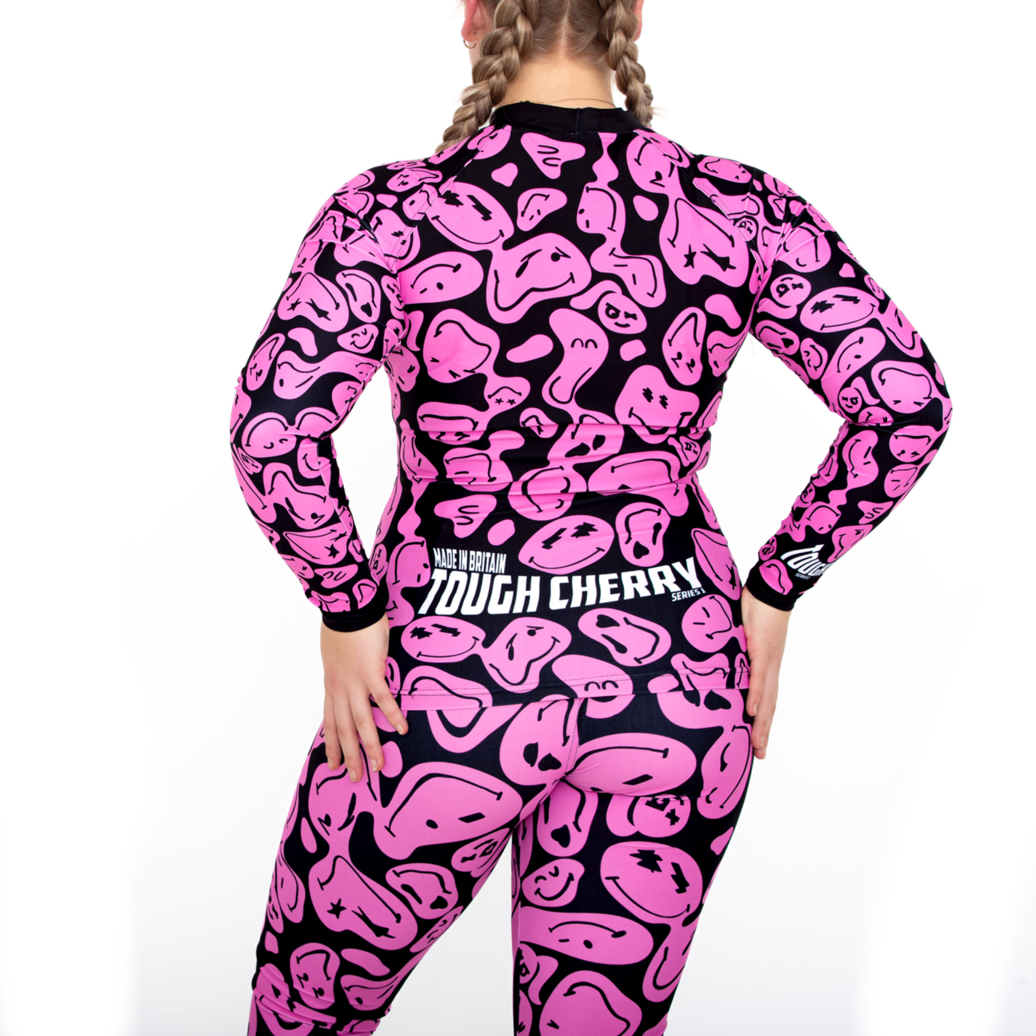 Women's and kids long sleeved pink and black smiley face rash guard, back view