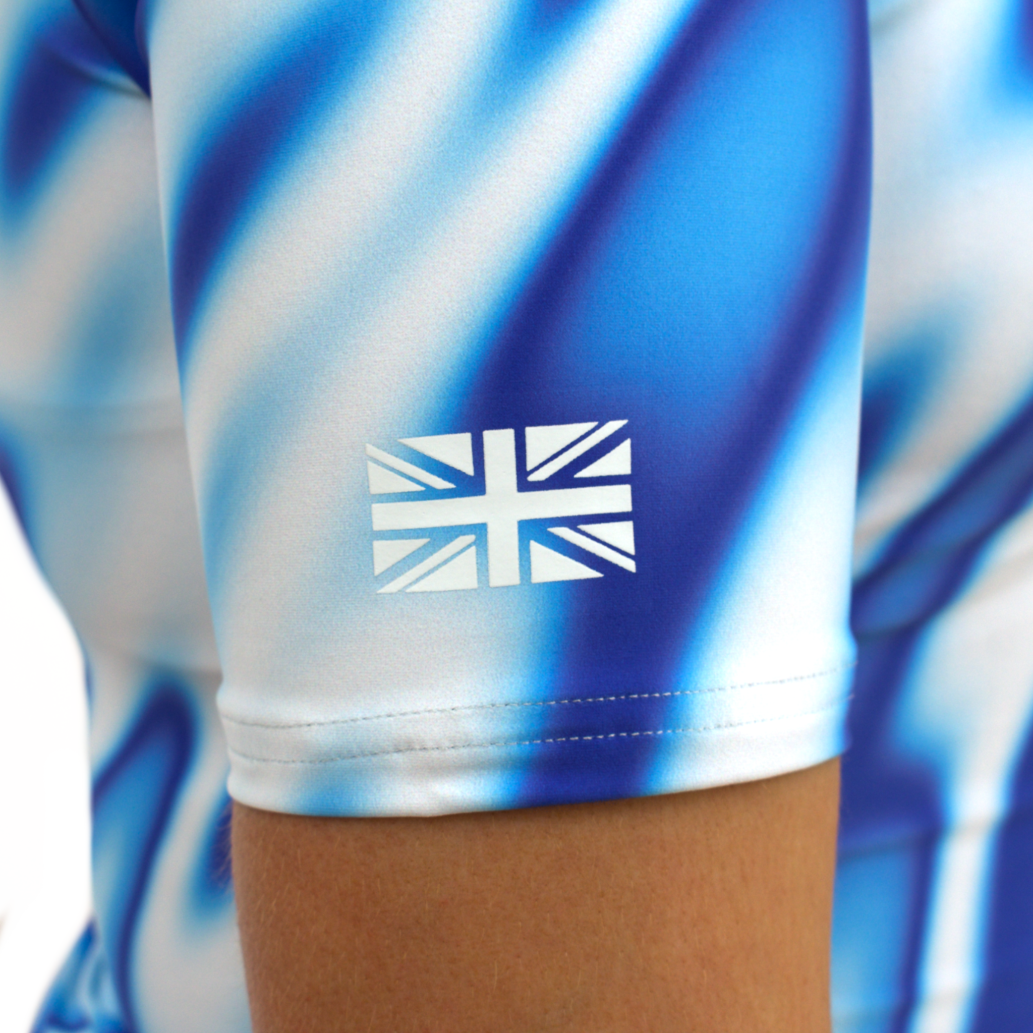 Women's and kids short and long sleeved rash guard, white and blue blurred design, british flag view