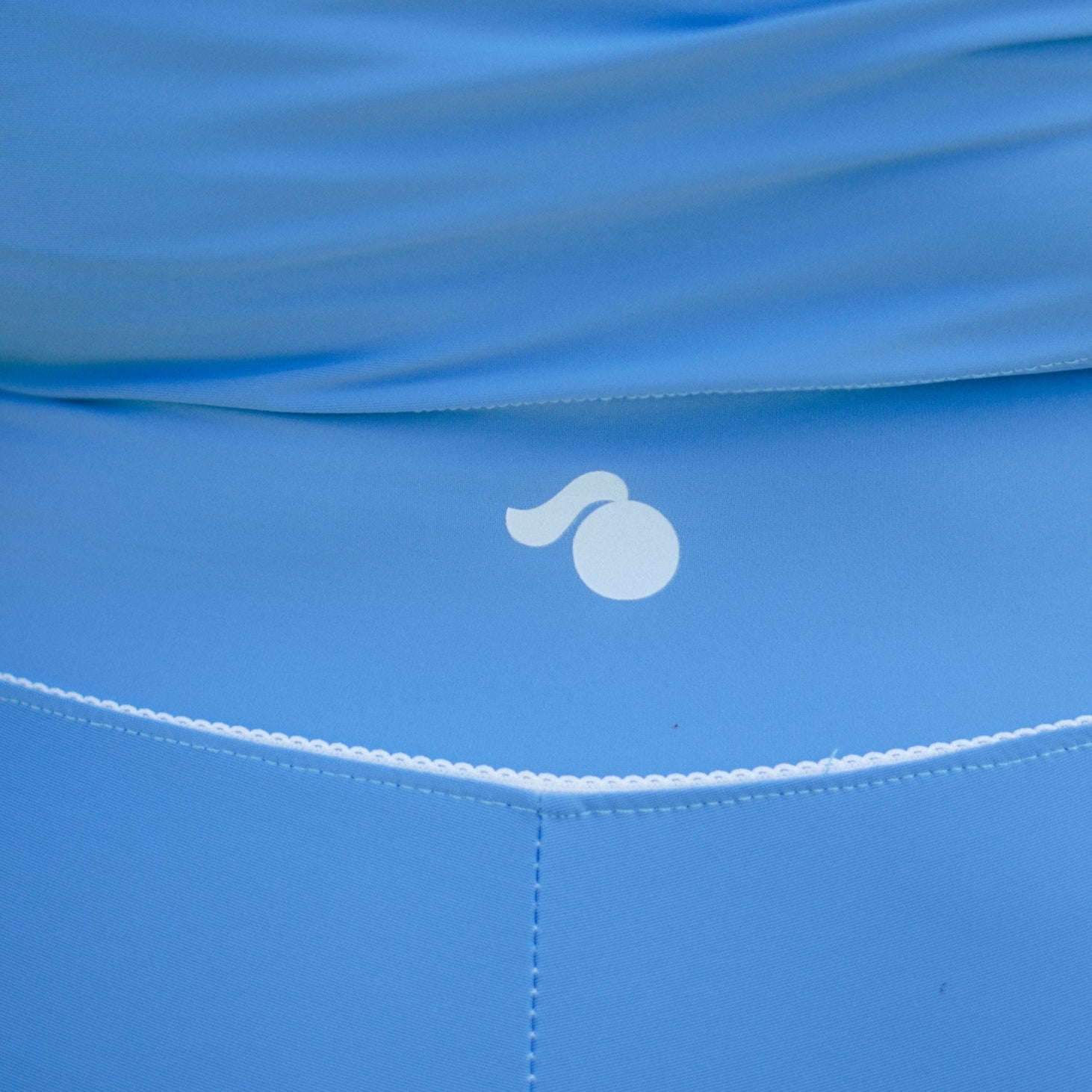 Close-up of a blue fabric with a tough cherry logo from petal collection