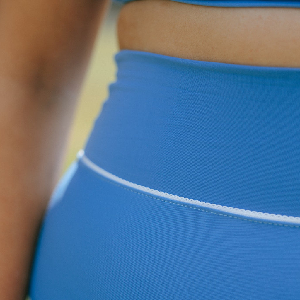 Close-up of a blue tough cherry outfit with a blurred background with lace detailing