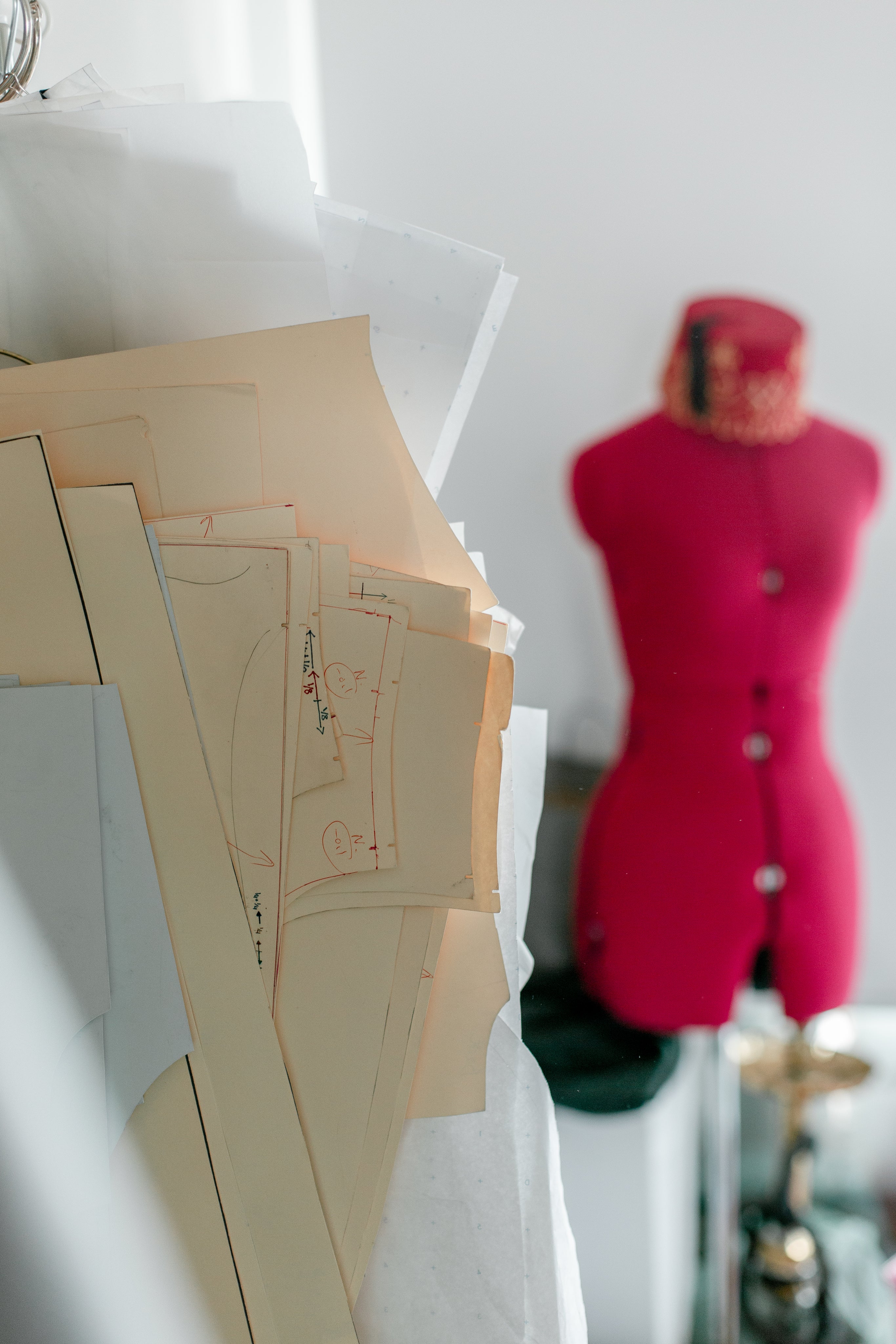 sewing patterns with pink mannequin in the background 